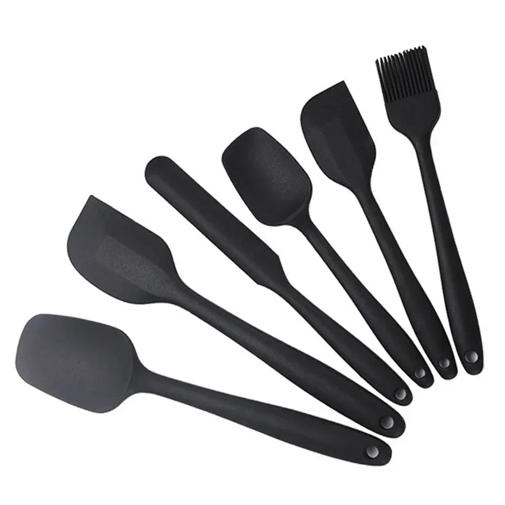 Black silicone kitchen utensil set with spatulas and basting brush for cooking and baking