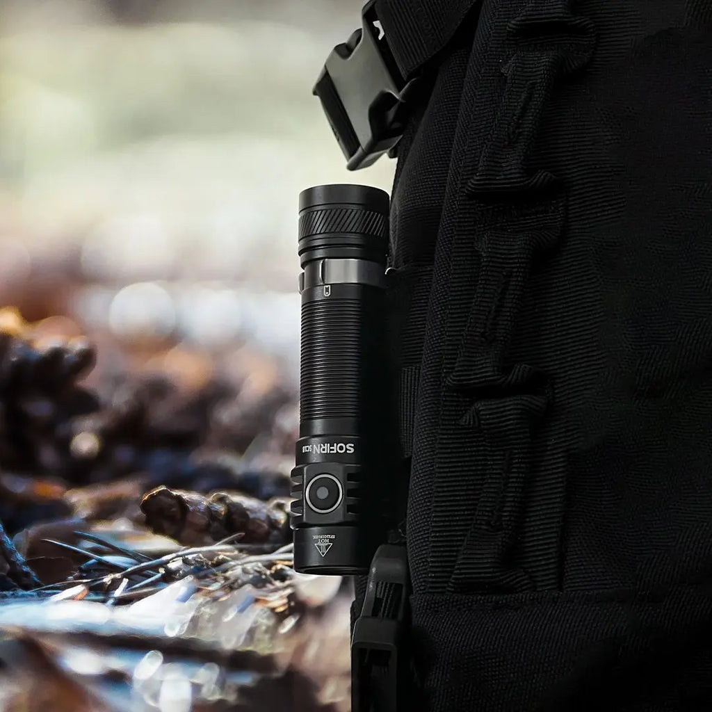 Sofirn flashlight attached to tactical backpack, ideal for outdoor safety and on-the-road adventures