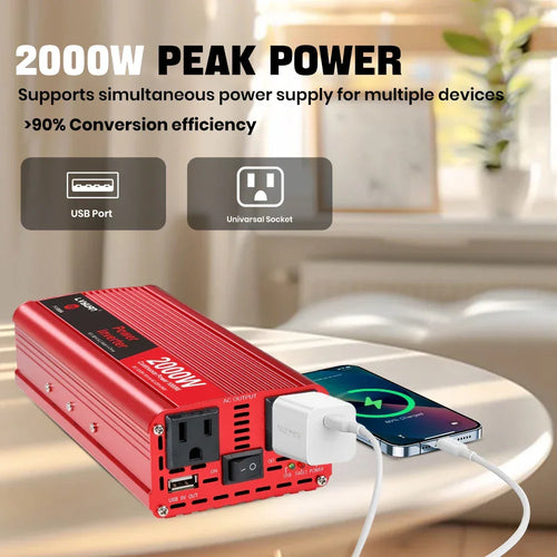 Red 2000W power inverter charging phone via USB port, ideal for on-the-road use with high efficiency