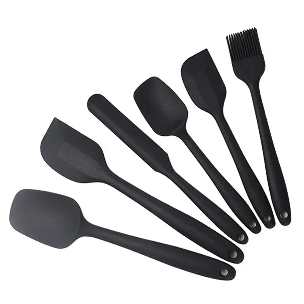 Black silicone kitchen utensil set with spatulas and basting brush for cooking and baking